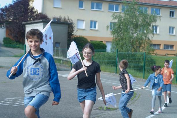Les élèves défilent avec les drapeaux